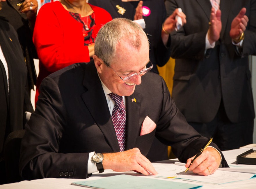 New Jersey Governor signing documents